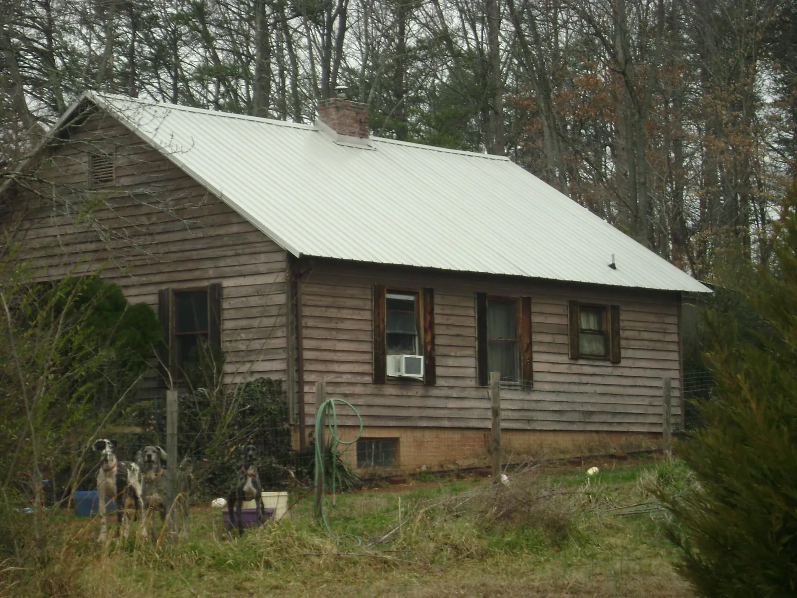 White metal roof on an old wood sided farmhouse, from a Metal Roof Installation job in Great Meadows